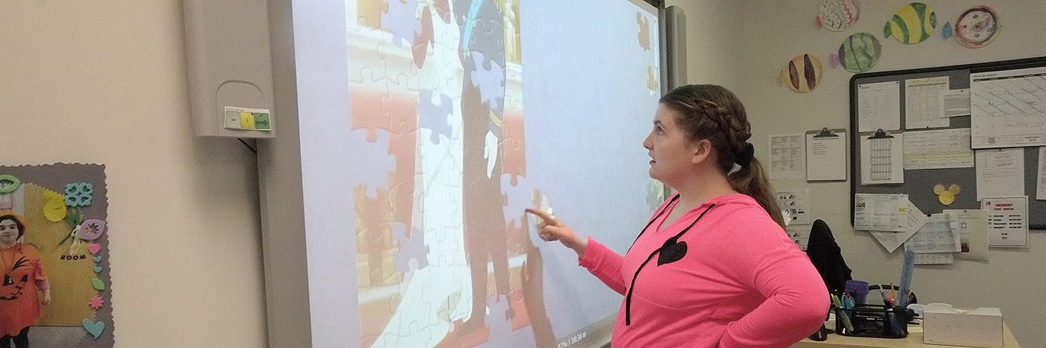 woman doing puzzle on a smart board