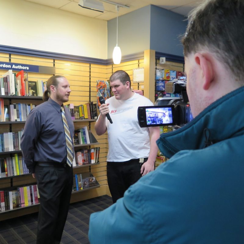 Men conducting interview in a library